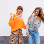 couple-young-women-having-fun-together-windy-hairs-two-girls-fooling-around-dancing-white_273443-1851